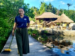 Iluh sweeping the private jetty at Ceningan Divers